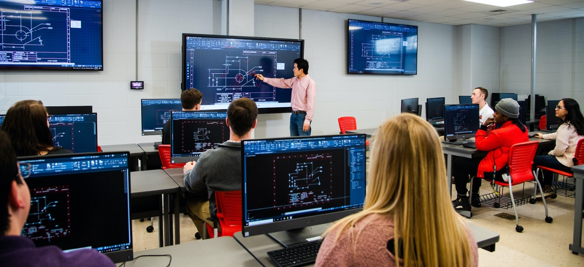 Professor and students in design lab